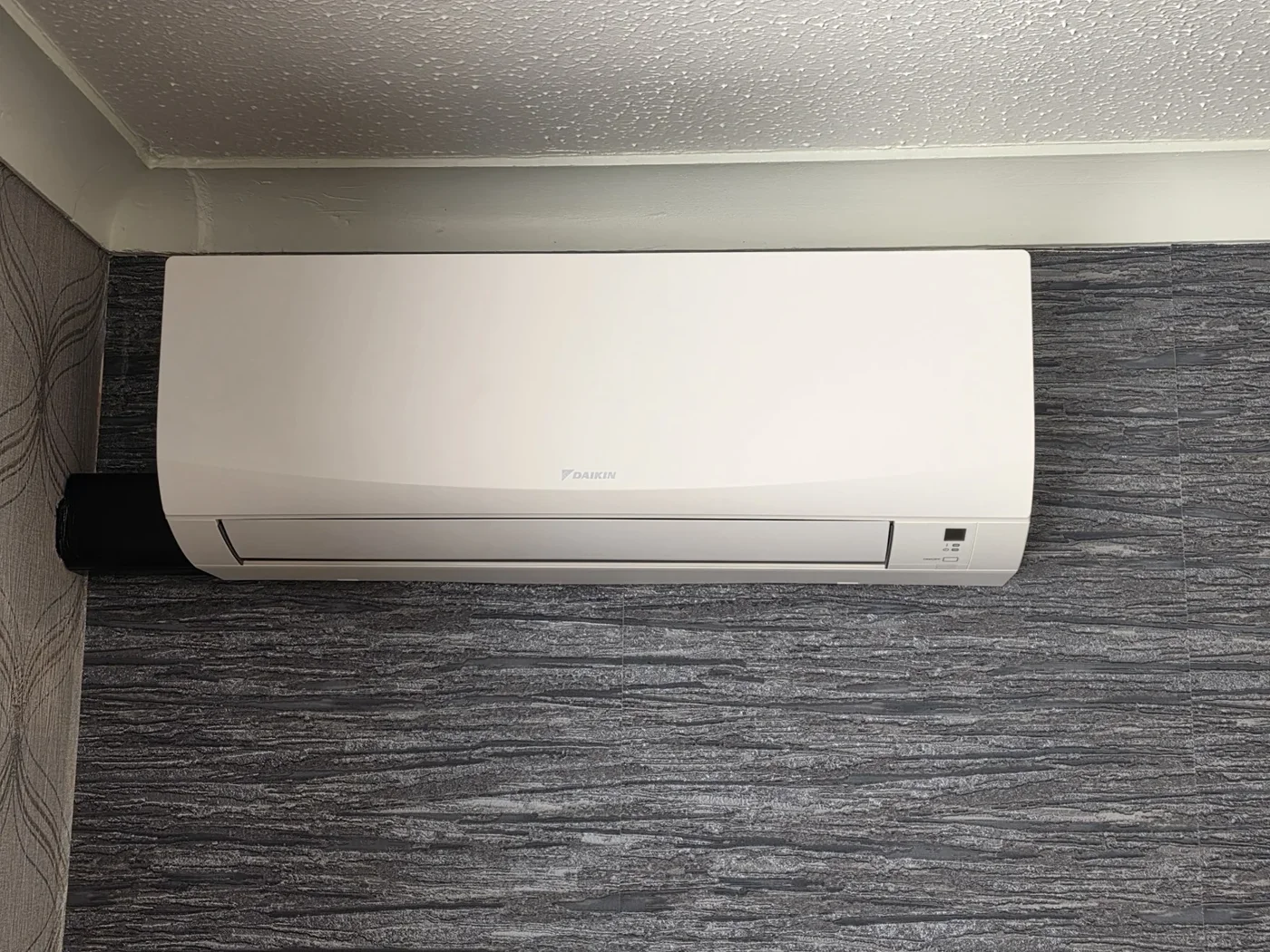 White wall-mounted indoor air conditioning unit