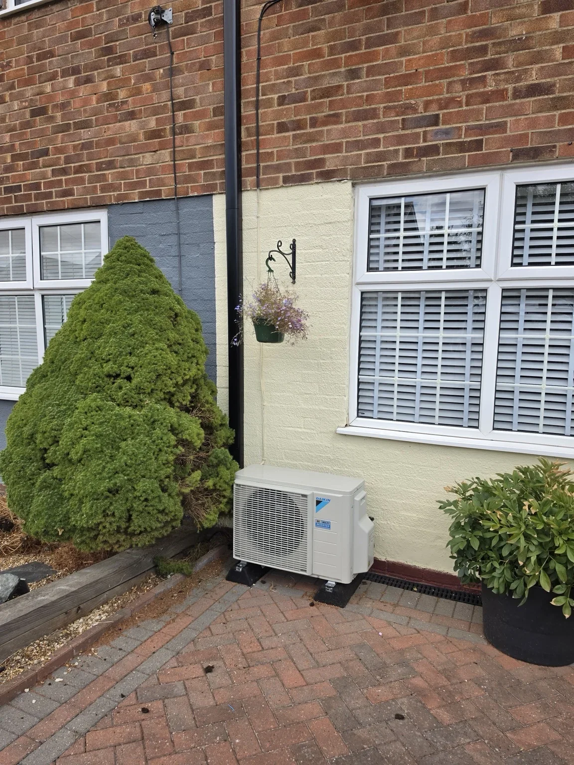 Air conditioning outdoor unit beside a house
