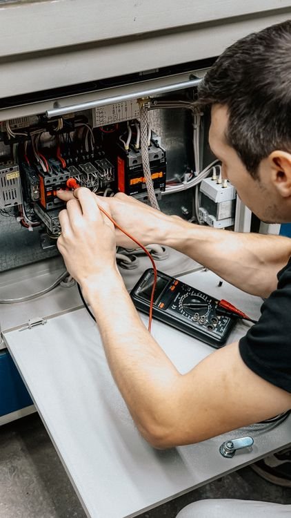 Electrician inspecting an electrical panel
